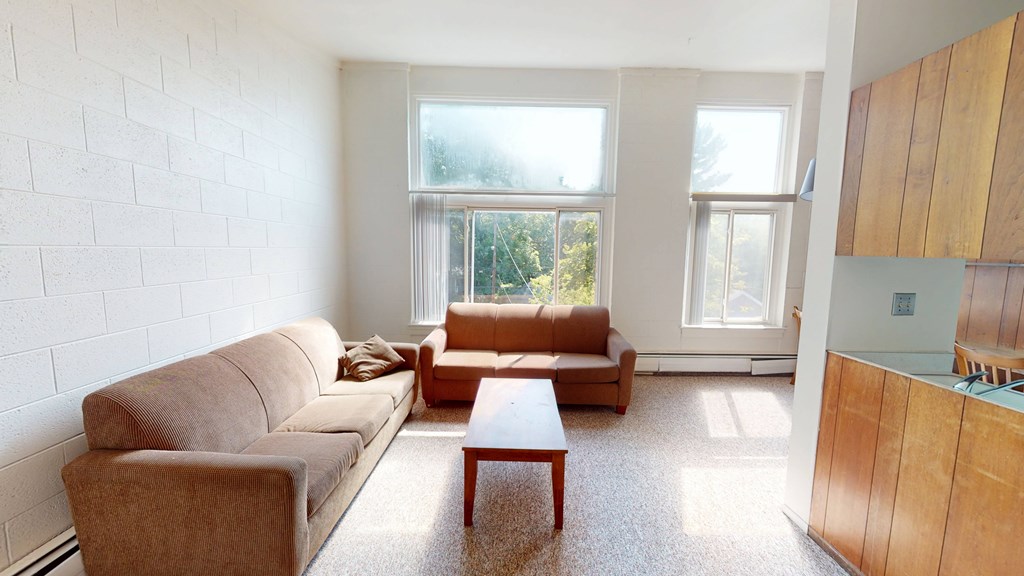 A living room with a couch, chair, and coffee table.