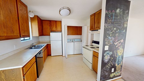 A kitchen with wooden cabinets and a mural on the wall.