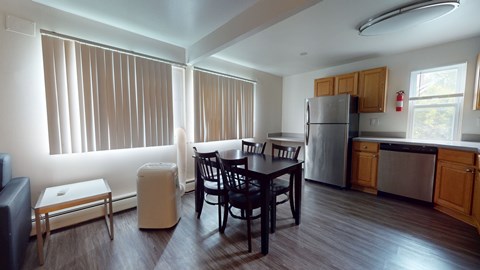 A kitchen with a table and chairs in the middle of the room.