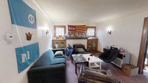 A living room with a couch, chairs, and a coffee table.