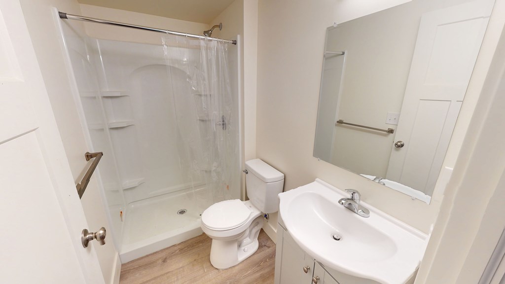 A white toilet sits next to a sink in a small bathroom.
