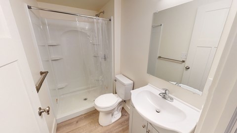 A white toilet sits next to a sink in a small bathroom.
