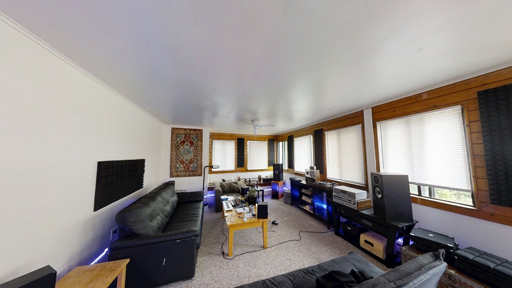 A living room with a black couch and a coffee table.