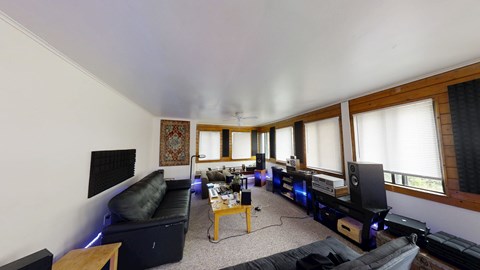 A living room with a black couch and a coffee table.