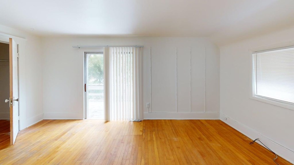 A room with wooden floors and white walls.
