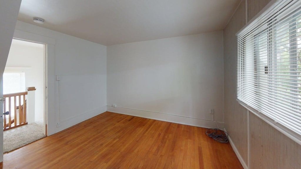 A room with wooden floors and white walls.