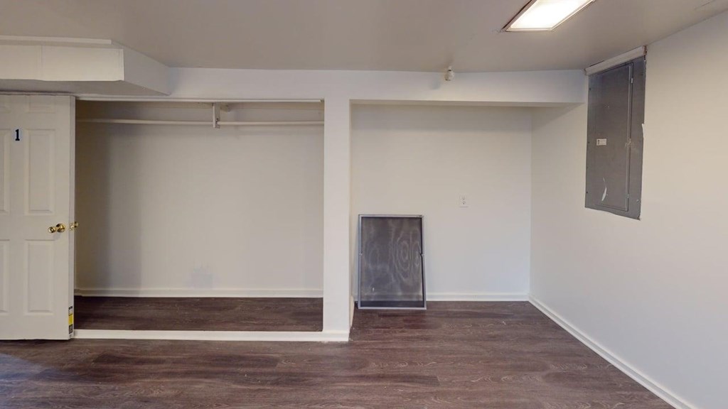 A room with a fireplace and a door on the left.