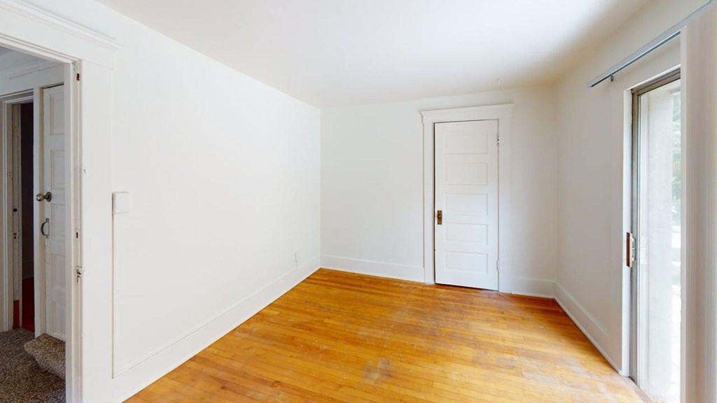 A room with wooden floors and white walls.