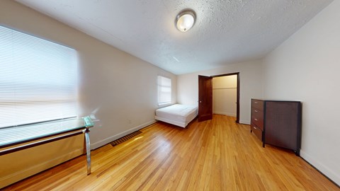 A room with a wooden floor and a white ceiling.
