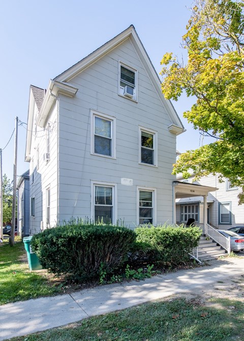A two-story house with a grey exterior and a white trim.