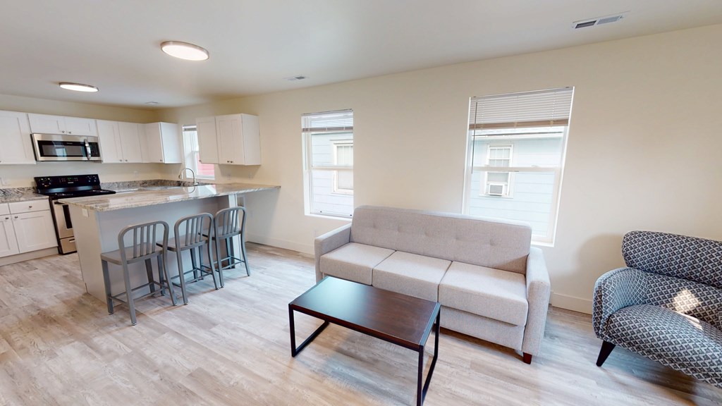 A kitchen with a dining table and chairs is shown.