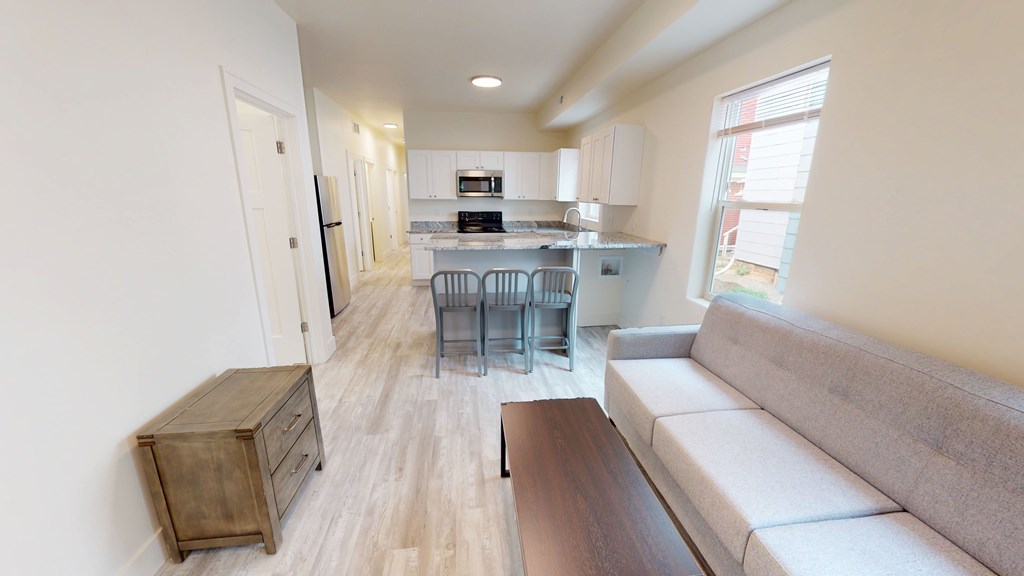 A kitchen with a table and chairs in the middle of the room.