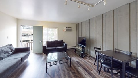 A living room with a couch, chair, and television.