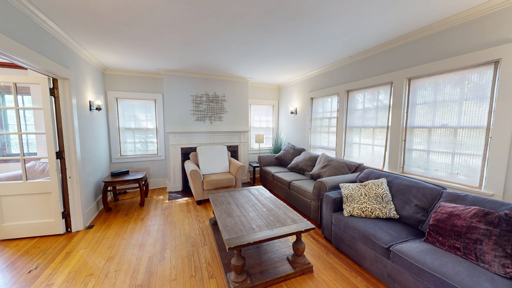 A living room with a grey couch and a wooden coffee table.