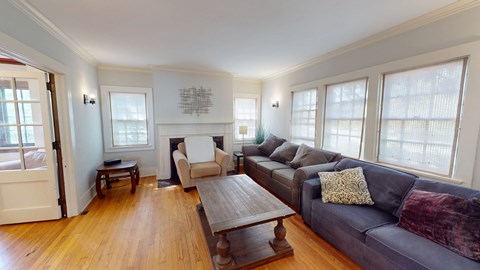 A living room with a grey couch and a wooden coffee table.