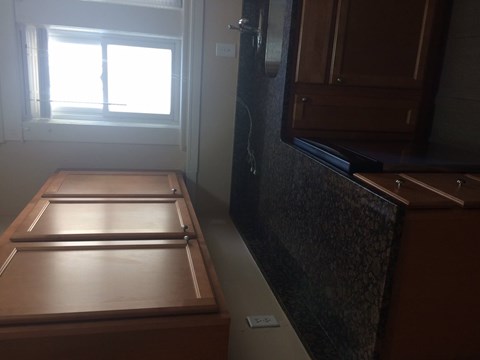A kitchen with a wooden table and a window.