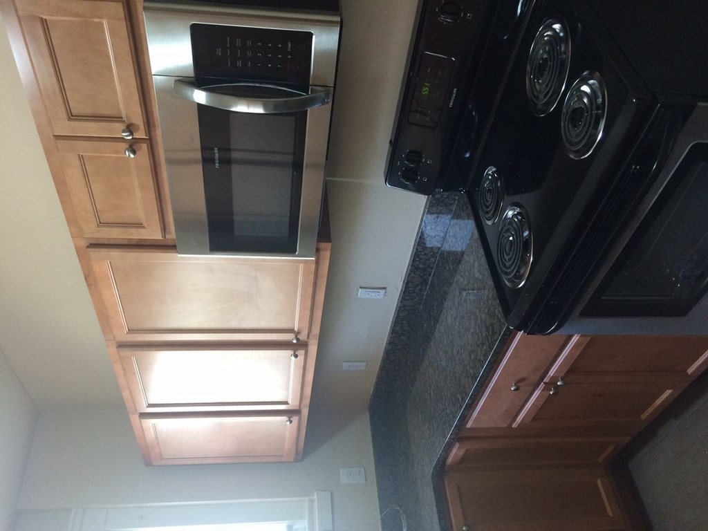 A black oven with a digital display is on the right side of the image.