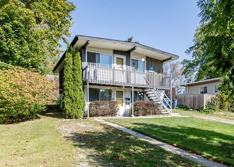 A house with a balcony and a staircase leading to the second floor.