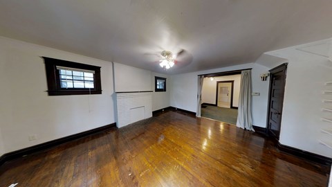 A room with wooden floors and white walls.