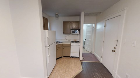 A kitchen with white appliances and a white refrigerator.