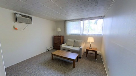 A living room with a couch, a lamp, and a table.