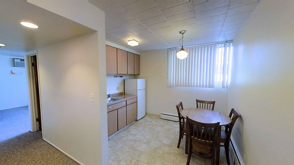 A room with a table and chairs in it.