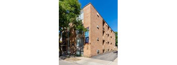 A tall brick building with a sign that says 920 on it.
