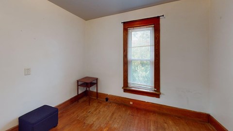 A room with a window and a small table.