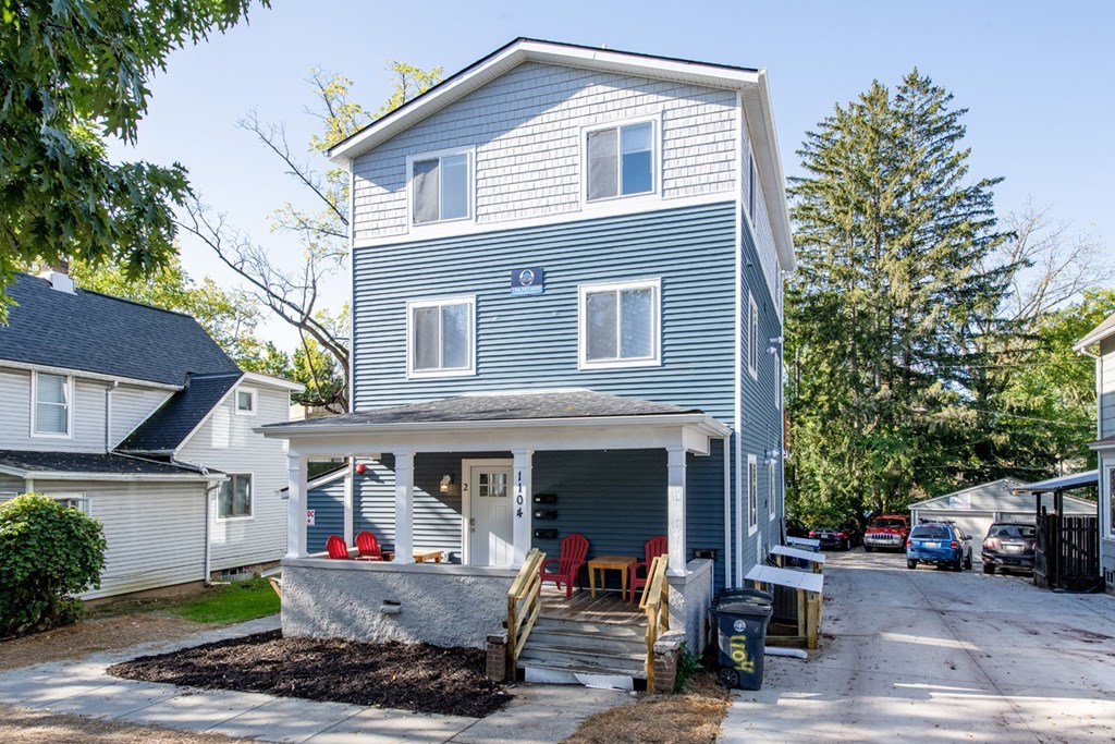 A two-story house with a garage and a covered porch.
