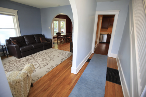A living room with a couch and a chair.