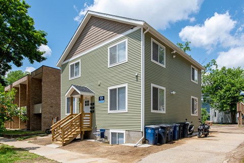 A two-story house with a garage and a covered patio.