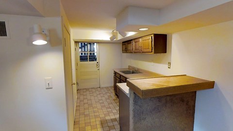 A kitchen with a counter and a sink.