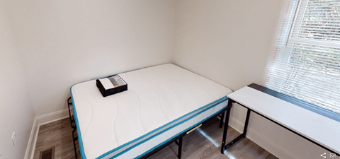 A small bedroom with a single bed and a window.