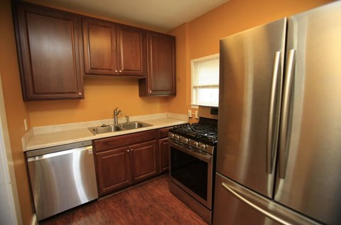 A kitchen with a stainless steel refrigerator and oven.