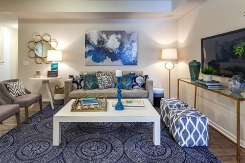 A living room with a white coffee table and a grey sofa.