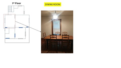 A dining room with a table and chairs.