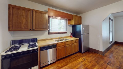 A kitchen with wooden cabinets and stainless steel appliances.