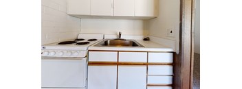 A white stove and sink in a kitchen.