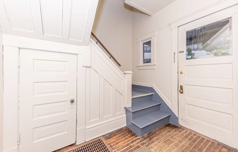 A white door is on the left and a white door is on the right.