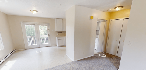 A white room with a door and a window.