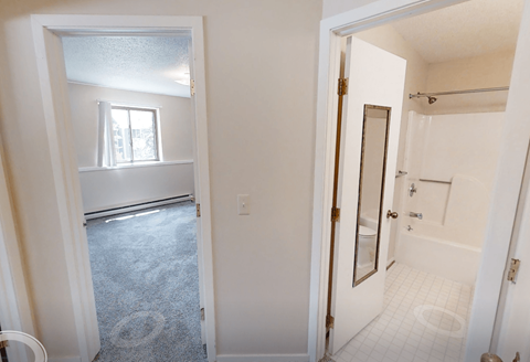 A bathroom with a toilet, sink, and shower.