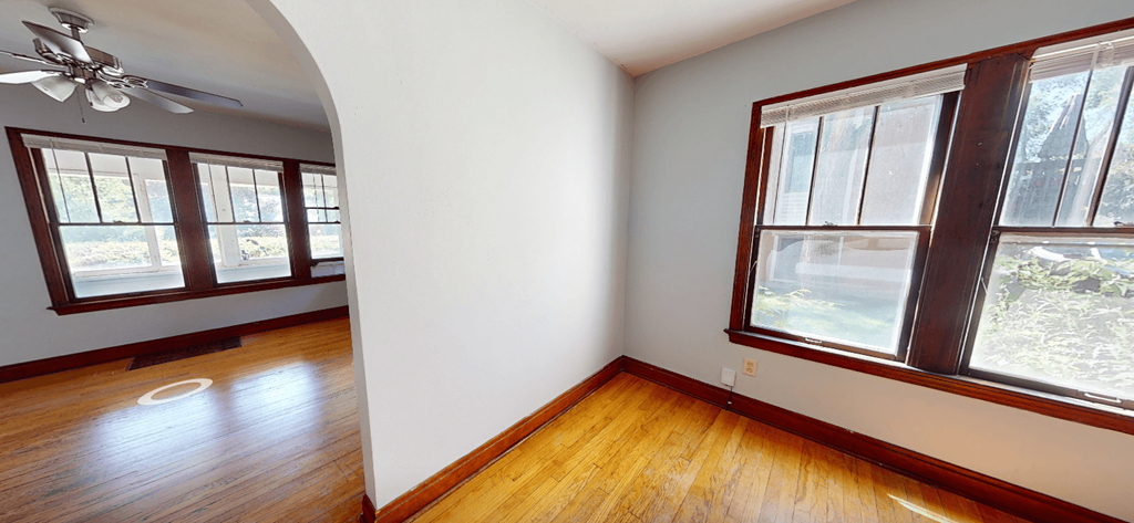 A room with a window and a fan.