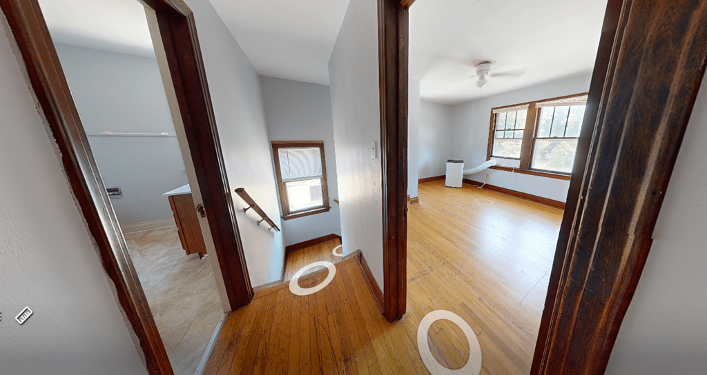 A room with wooden floors and white walls.