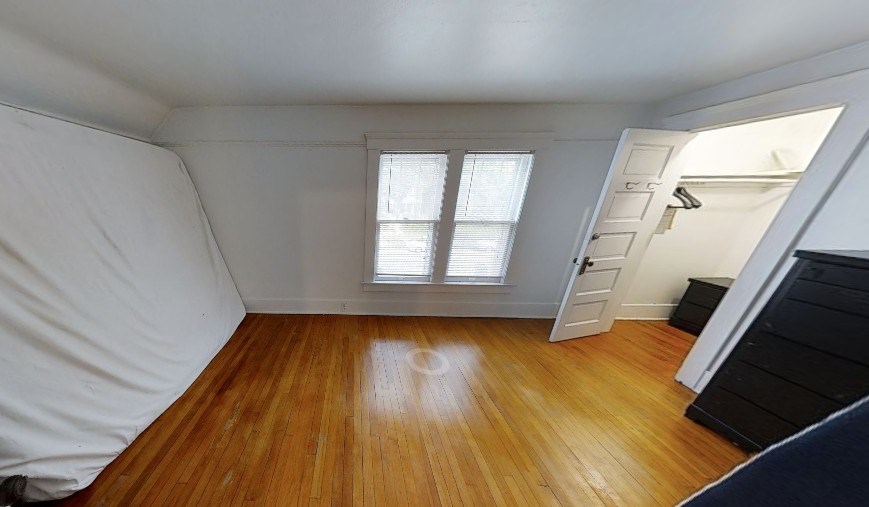 A room with wooden floors and a window.