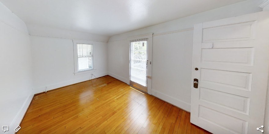 A room with a white door and a window.