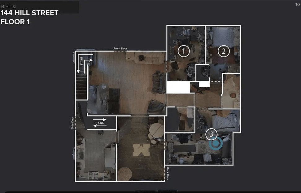 A floor plan of a room with a kitchen, living room, and bathroom.