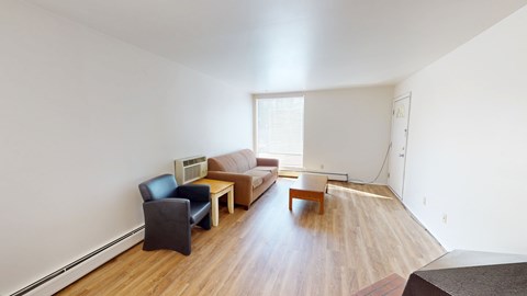 A living room with a couch, chair, and table.