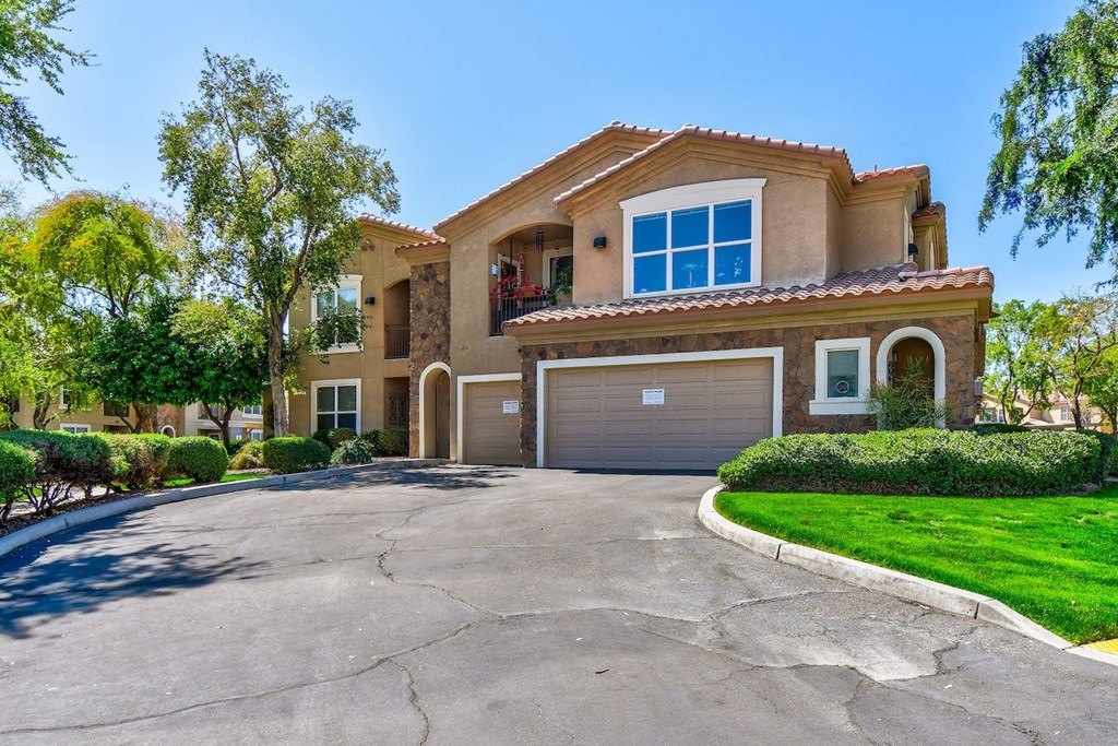 A large house with a driveway in front.