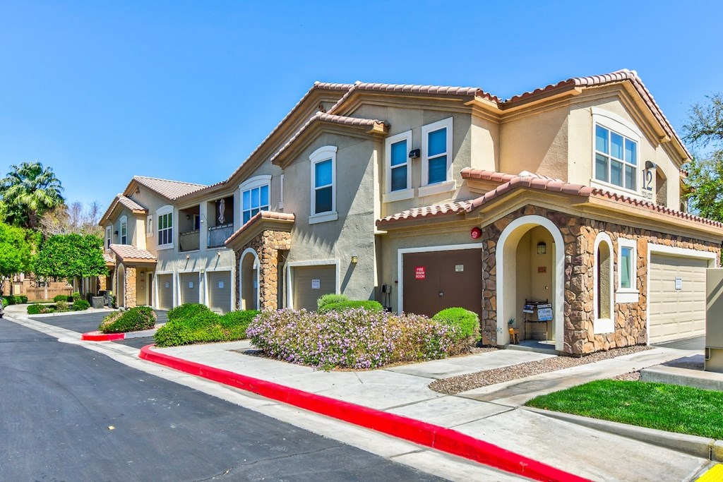 A row of houses with a red curb in front.