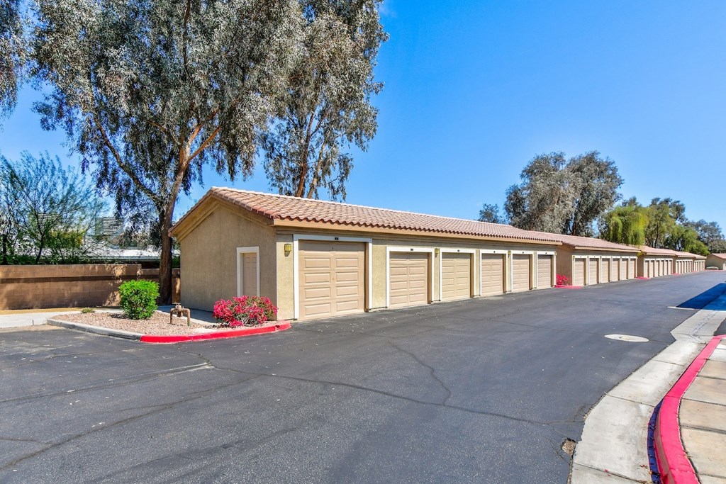 A row of garage doors are lined up on a street.